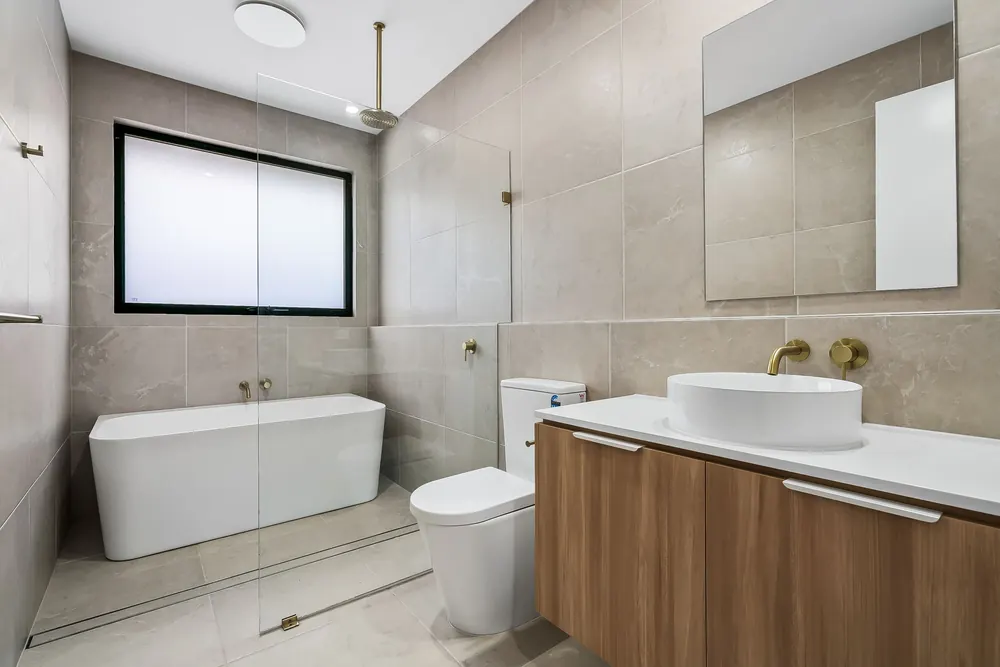 Freestanding bath and timber vanity in a modern Adelaide home bathroom