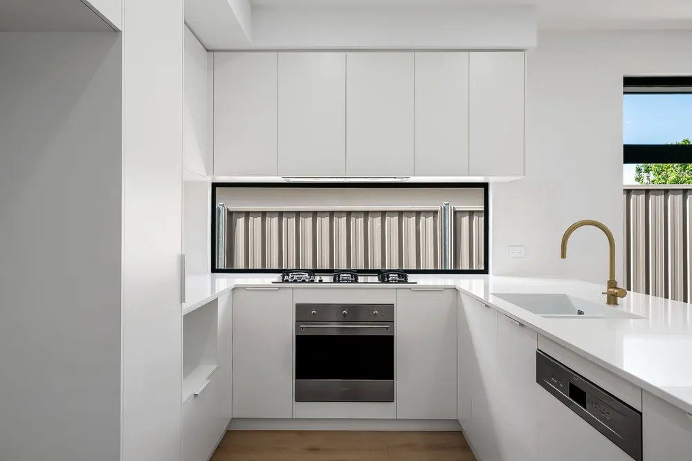 Modern kitchen with gas cooktop and brass tapware in an Adelaide home